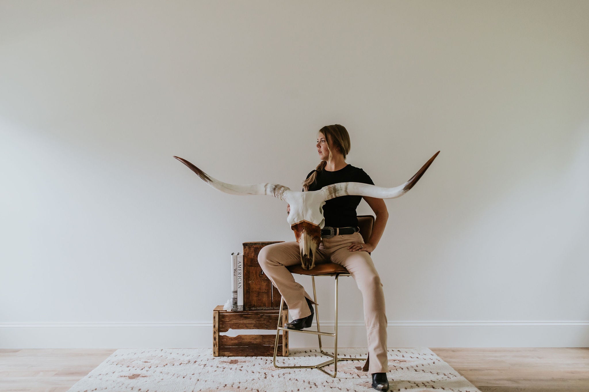 Wanderlust Skulls designer Cassie Everson holding a longhorn skull she designed