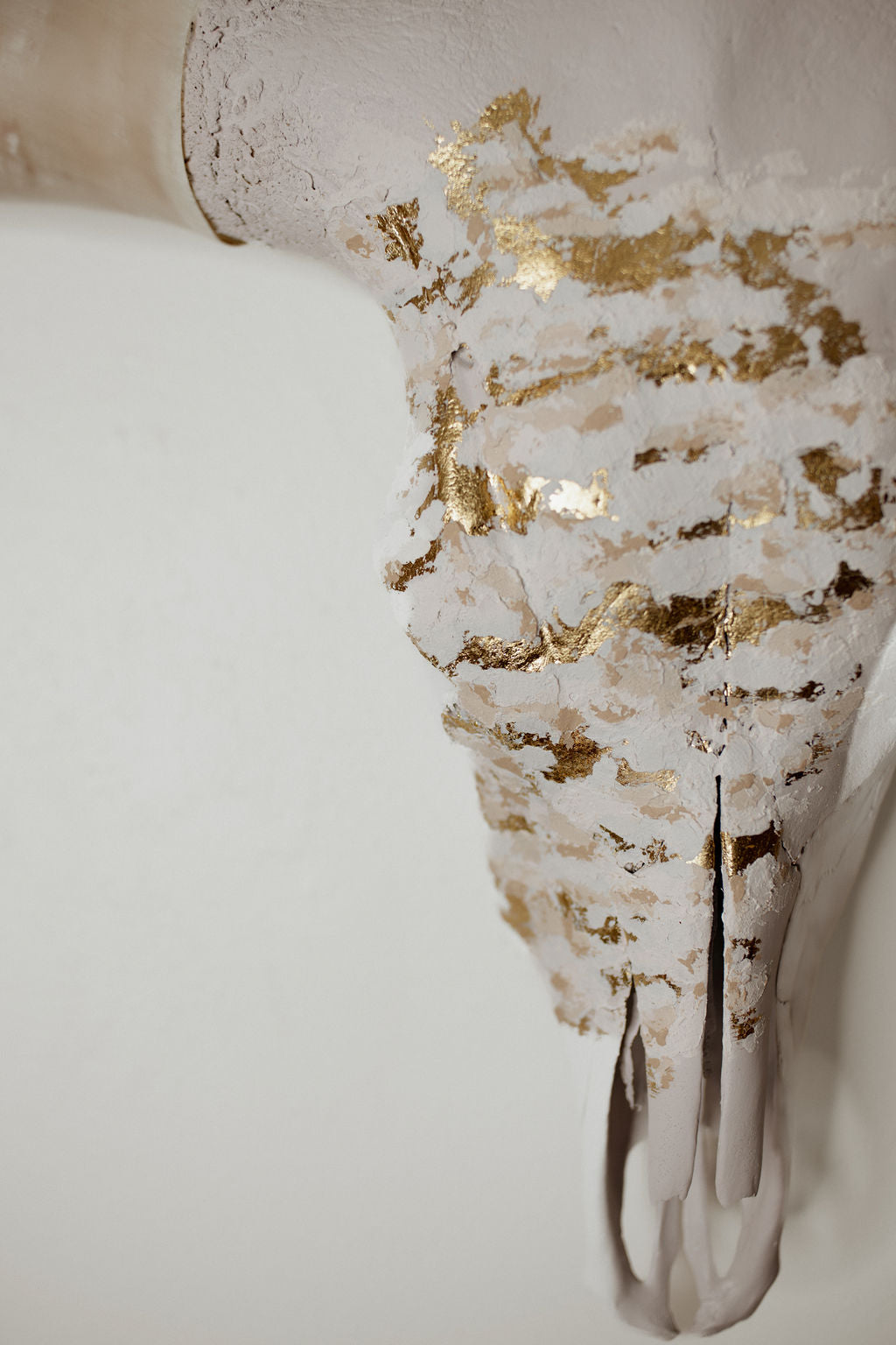 Decorative skull with gold leaf on a white background