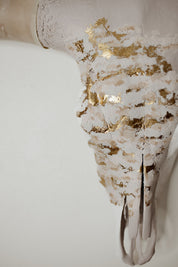 Decorative skull with gold leaf on a white background